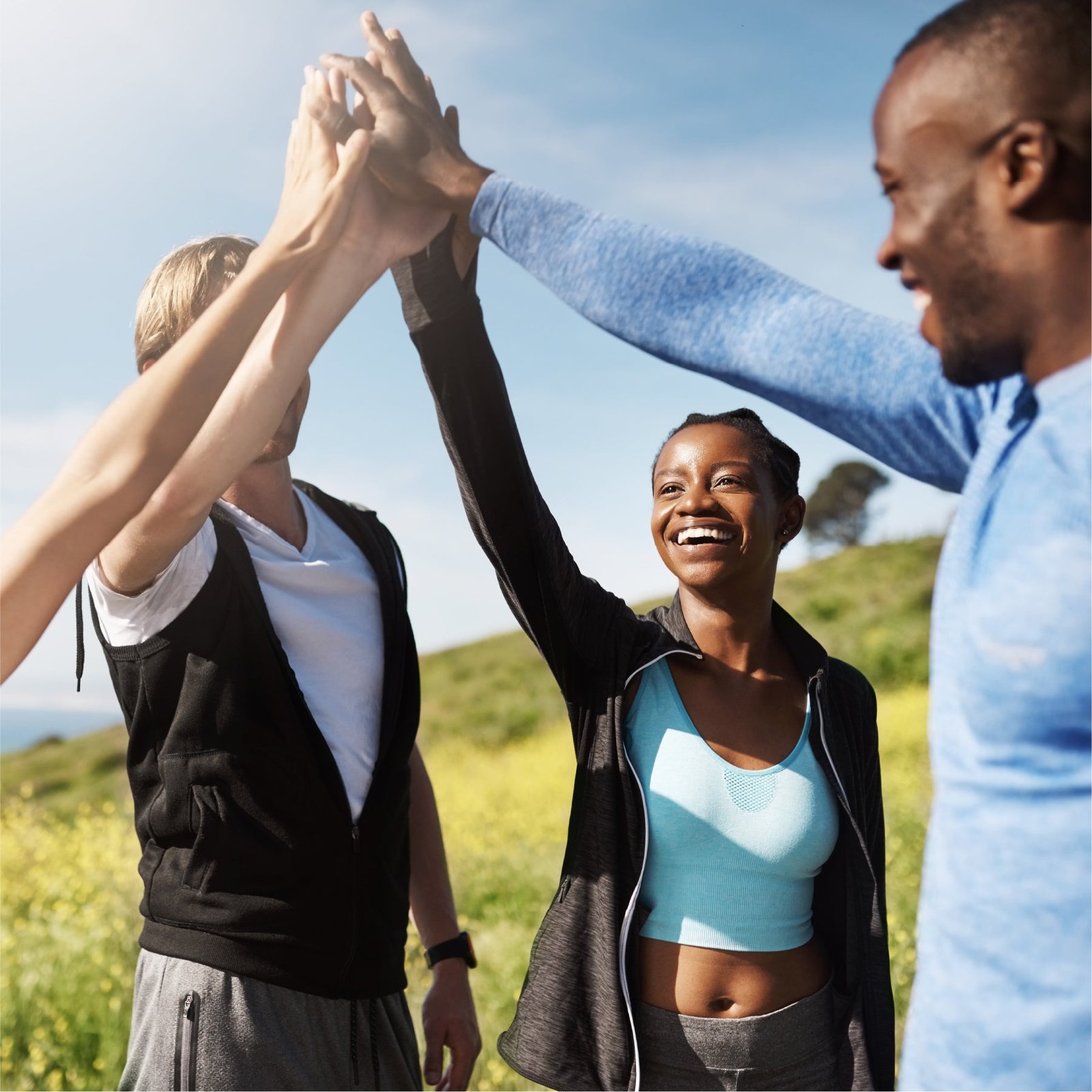 Friends giving a high five outdoors