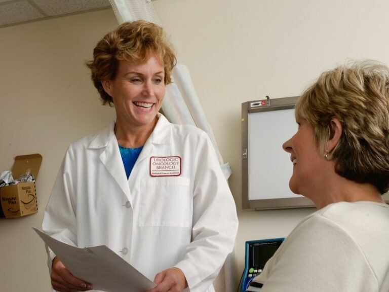 Smiling doctor talking with a patient