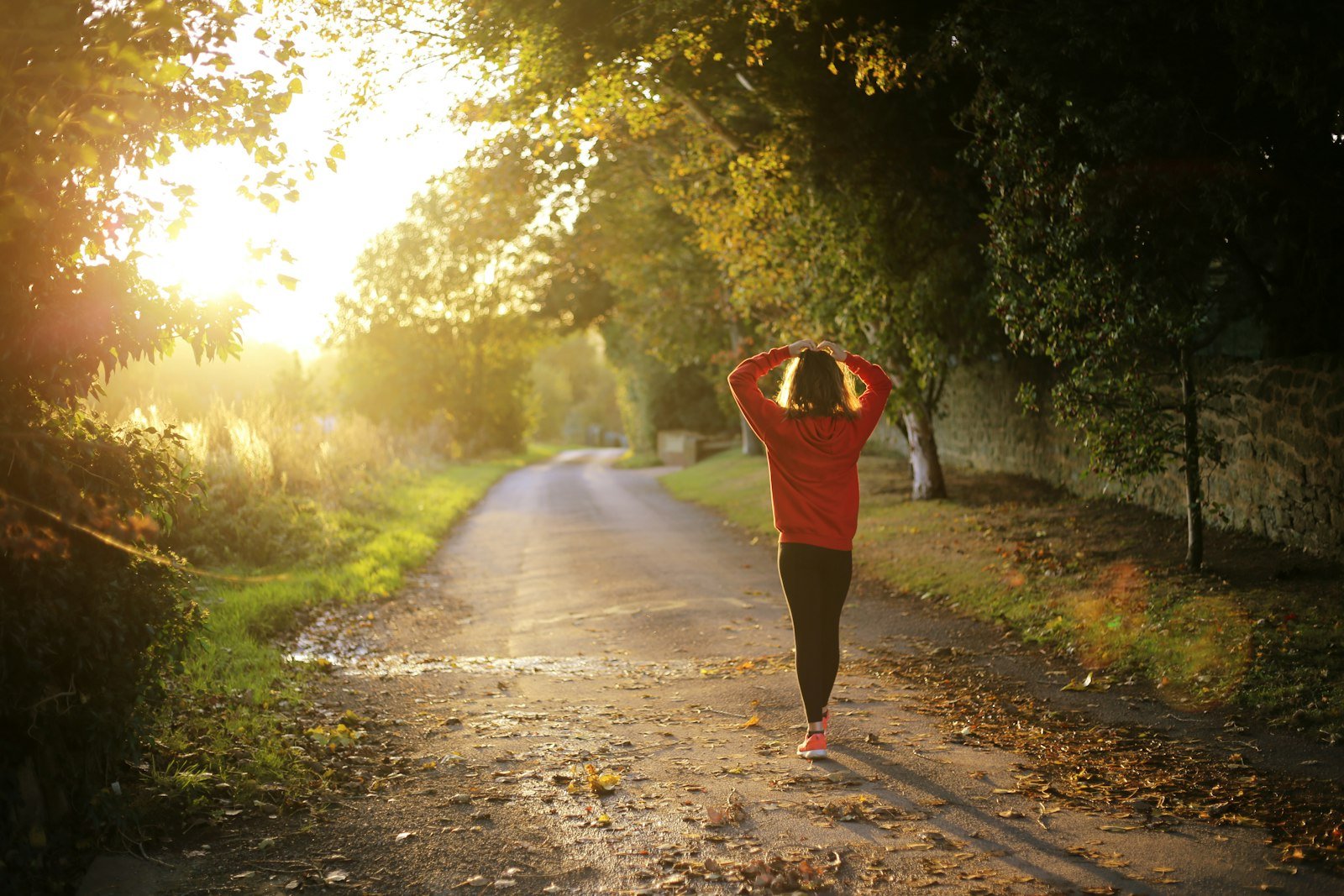 Woman walking outdoors on a sunny path
