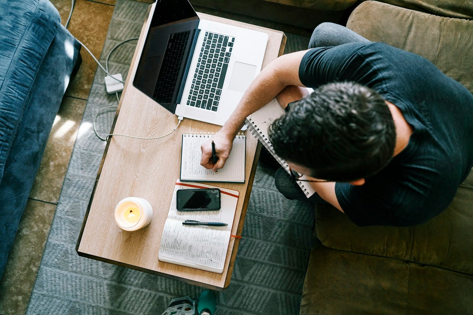 Man sitting at a table working on a laptop